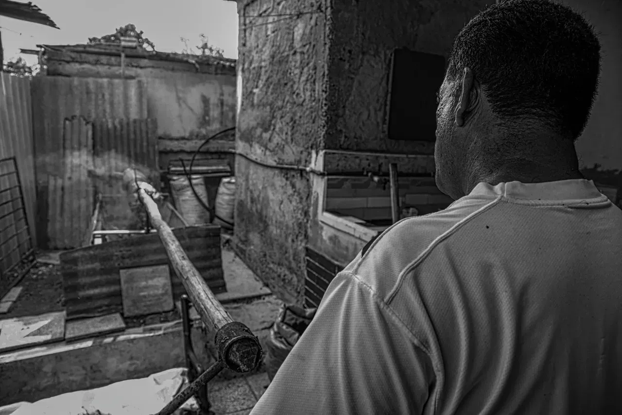 A man standing in front of an old building.