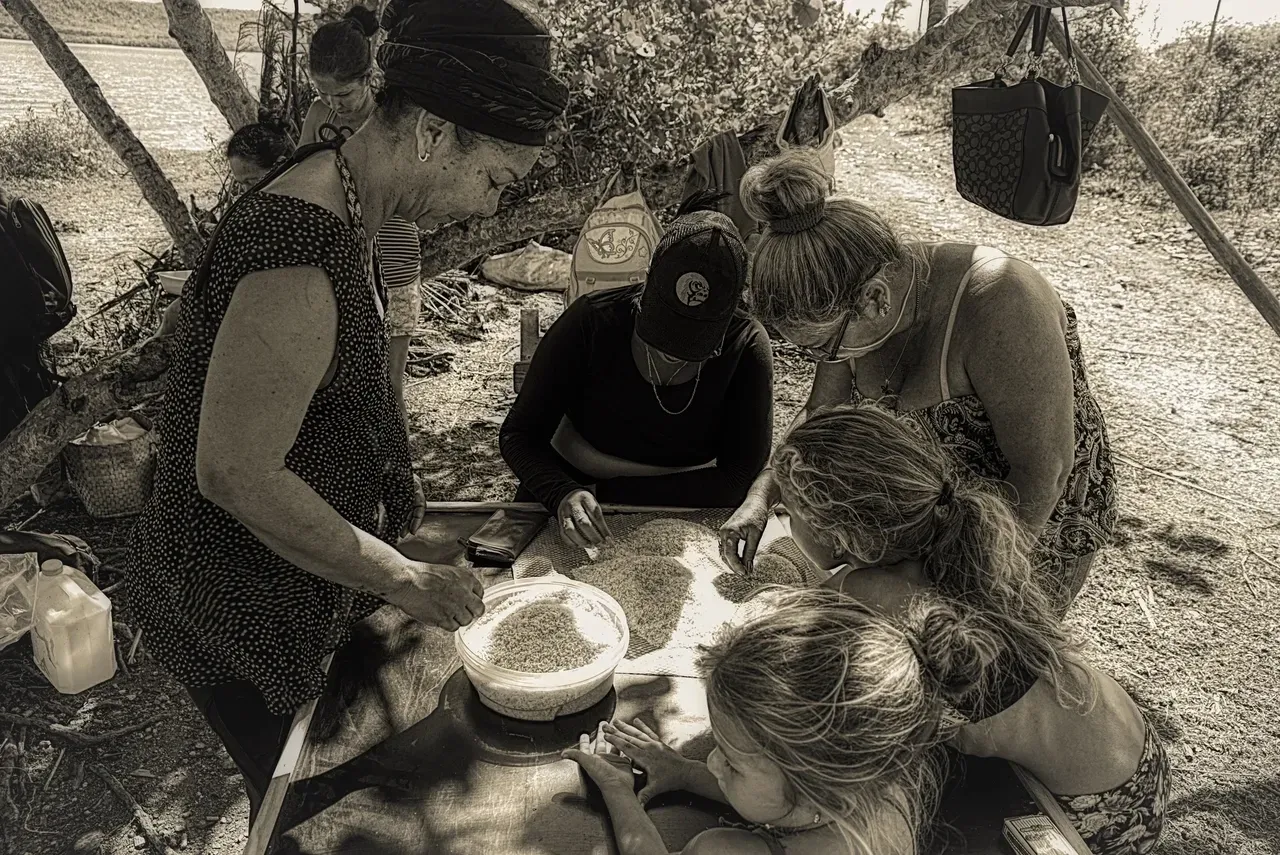 A group of people gathered around some food.